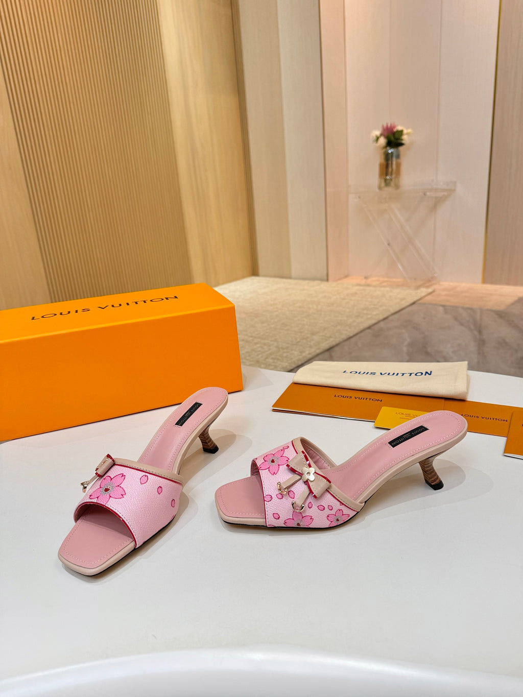 Pink Louis Vuitton ladies mules with open toe, flower embroidery, and block heel