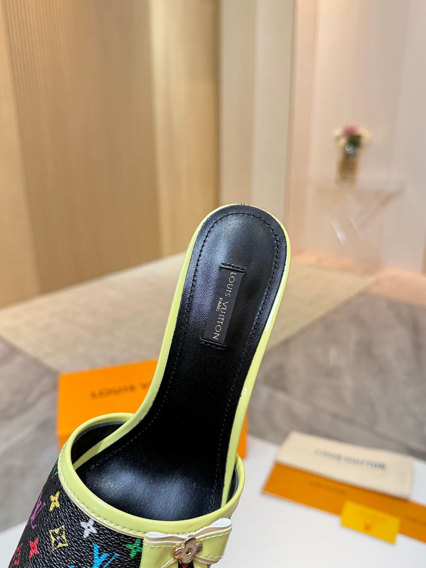 Louis Vuitton ladies mule sandal side view, lime green trim and black lining, kitten heel