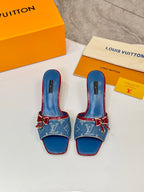 Louis Vuitton ladies blue monogram slide mules with red trim and bow hardware, front view
