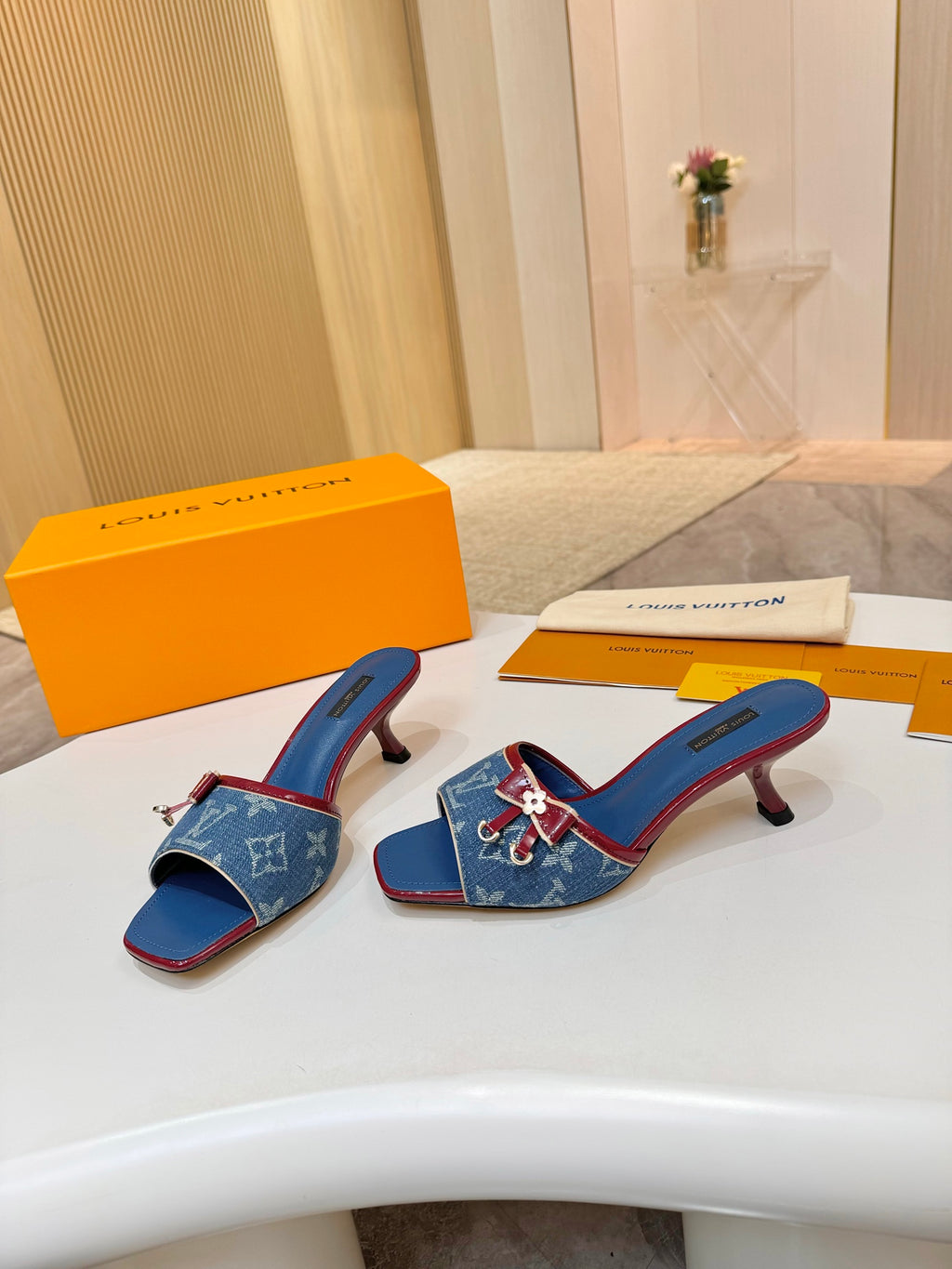 Louis Vuitton ladies blue monogram slide mules with red trim, shown as a pair