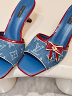 Louis Vuitton ladies blue monogram slide mules, red buckle strap and bow hardware, close-up