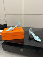 Hermes women's light-blue leather slingback sandals, angled view with slim stiletto heel