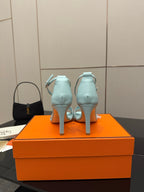 Hermes women's luxury shoes, light blue heeled sandals back view with ankle strap