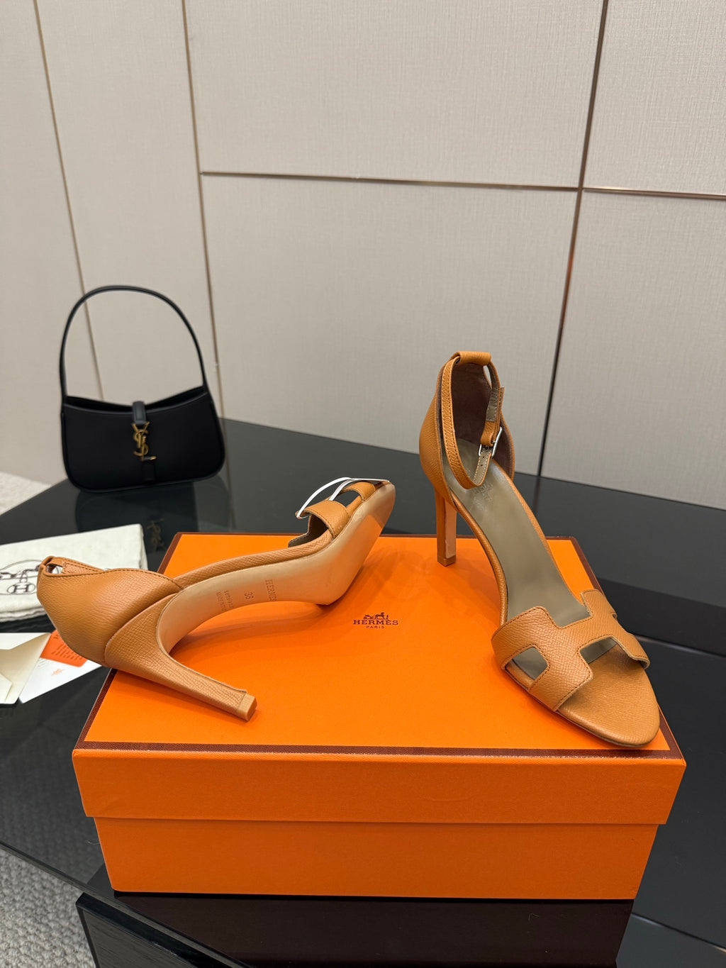 Hermes tan leather heeled sandals for ladies, open toe with ankle strap, angled view pair