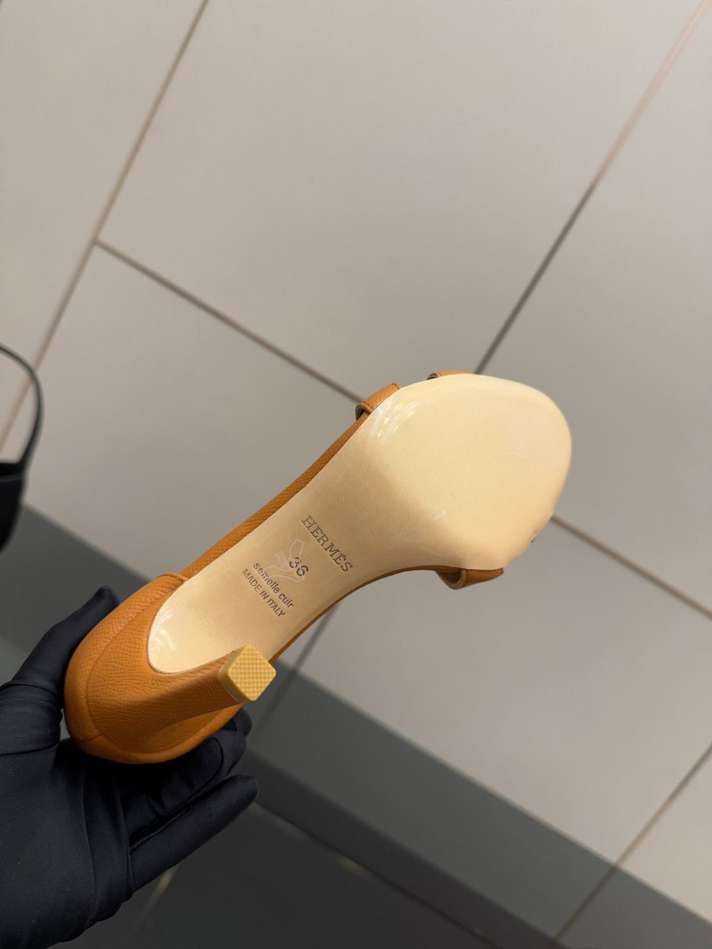 Hermes ladies tan sandal outsole and footbed view with brand text on insole