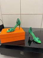 Hermes ladies green heeled sandals, side view on orange box with ankle sling