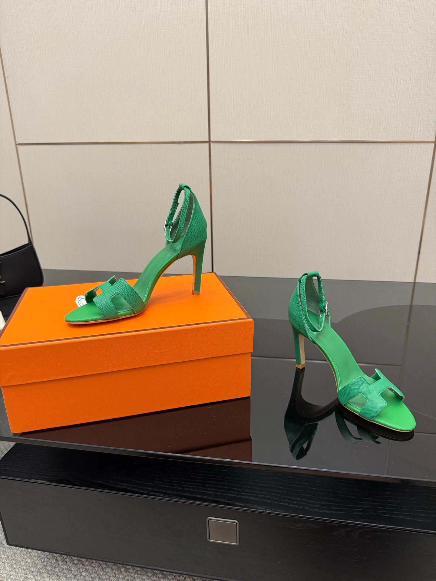 Hermes ladies green heeled sandals, side view on orange box with ankle sling