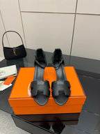 Black leather heeled mule sandals with square-toe cutouts and slip-on strap detail