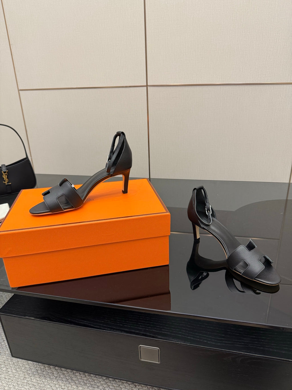 Black leather heeled mules with ankle strap detail and slim stiletto heel, side view