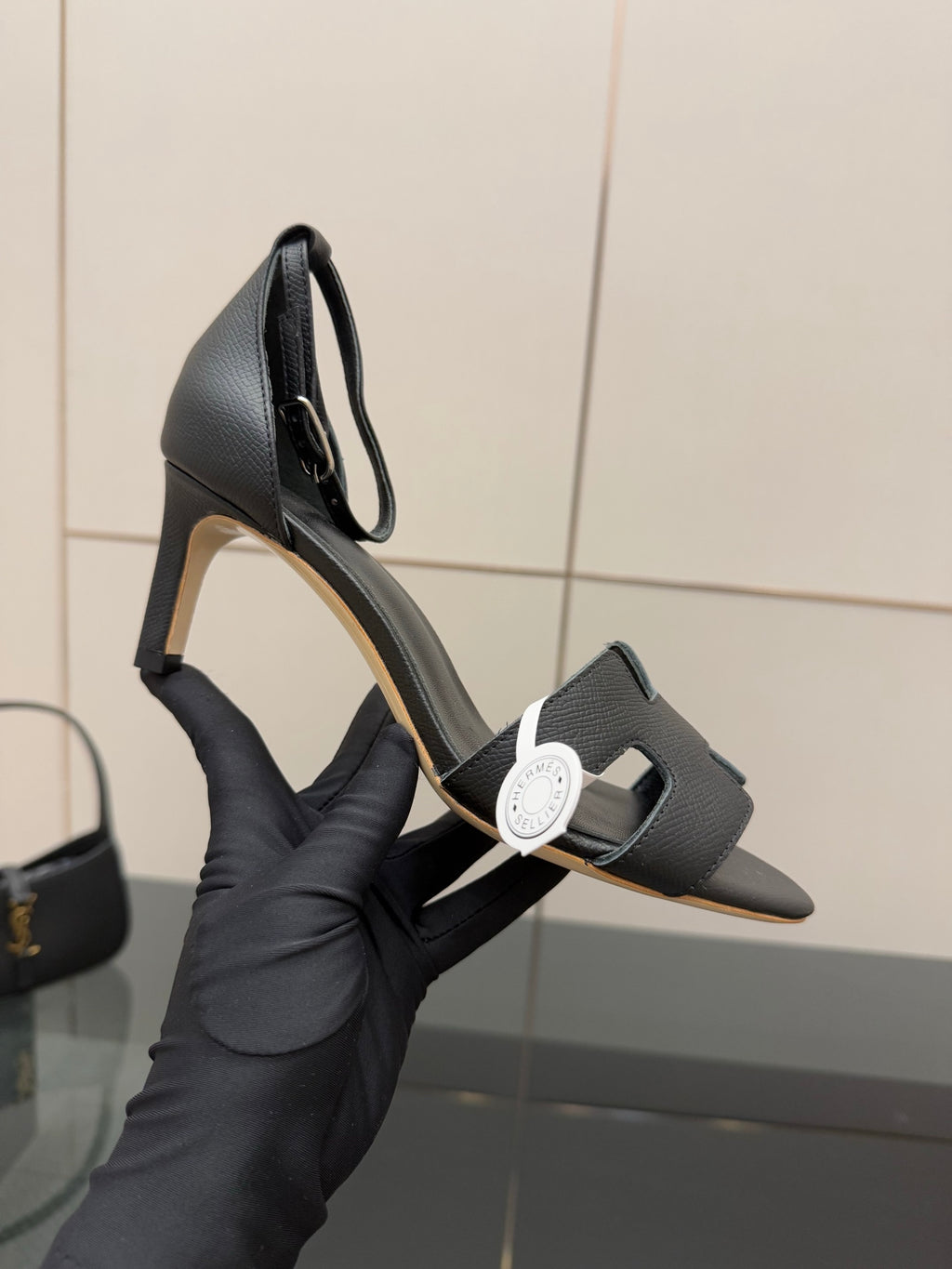 Black leather heeled mule sandals with square toe and adjustable strap, close-up
