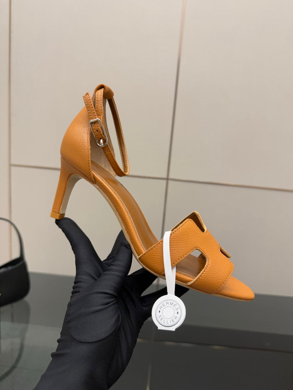 Tan leather heeled sandal with open toe and cutout ankle strap, side profile