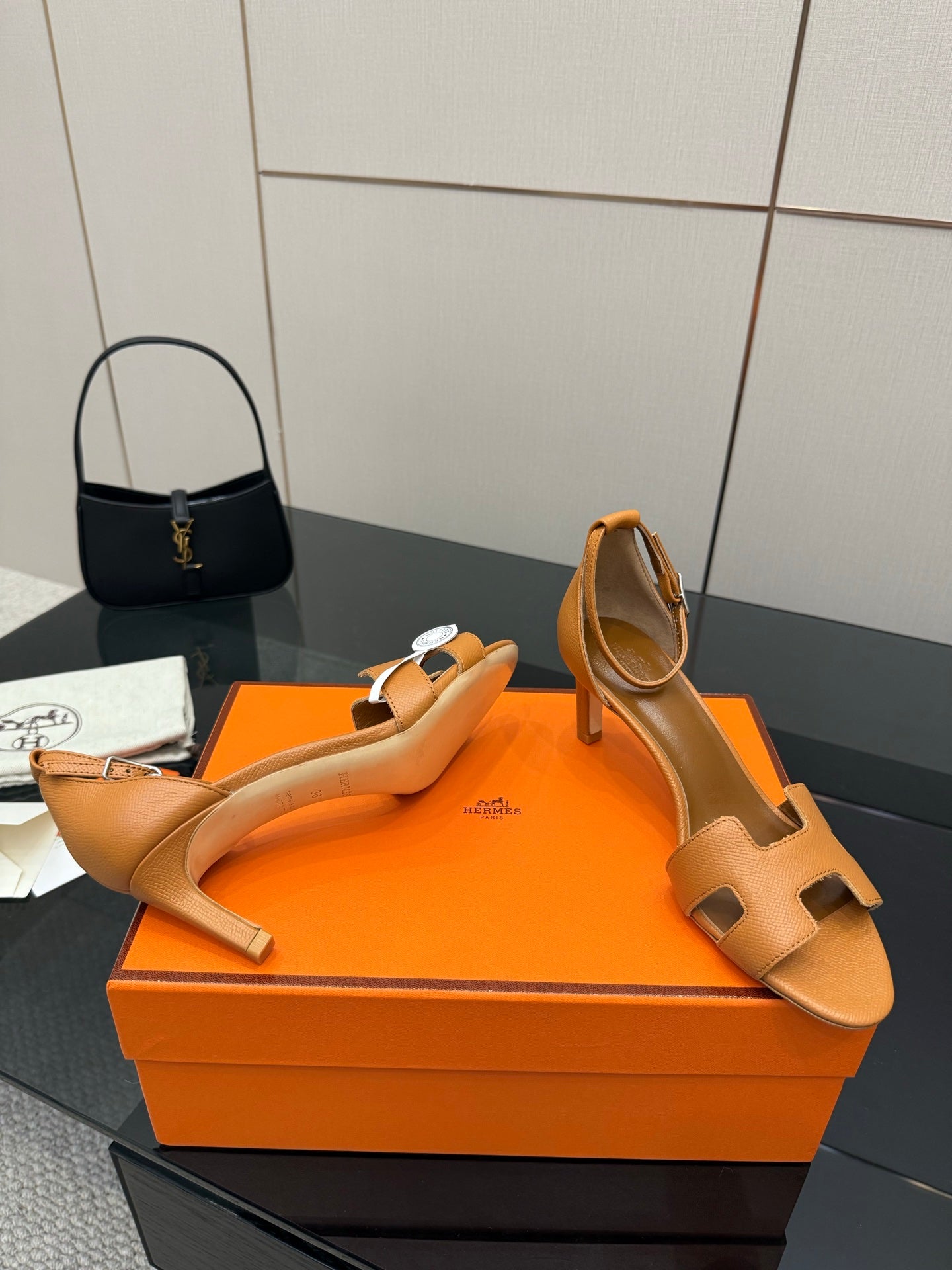 Tan leather heeled sandals with open toe and cutout H-style straps, angled view