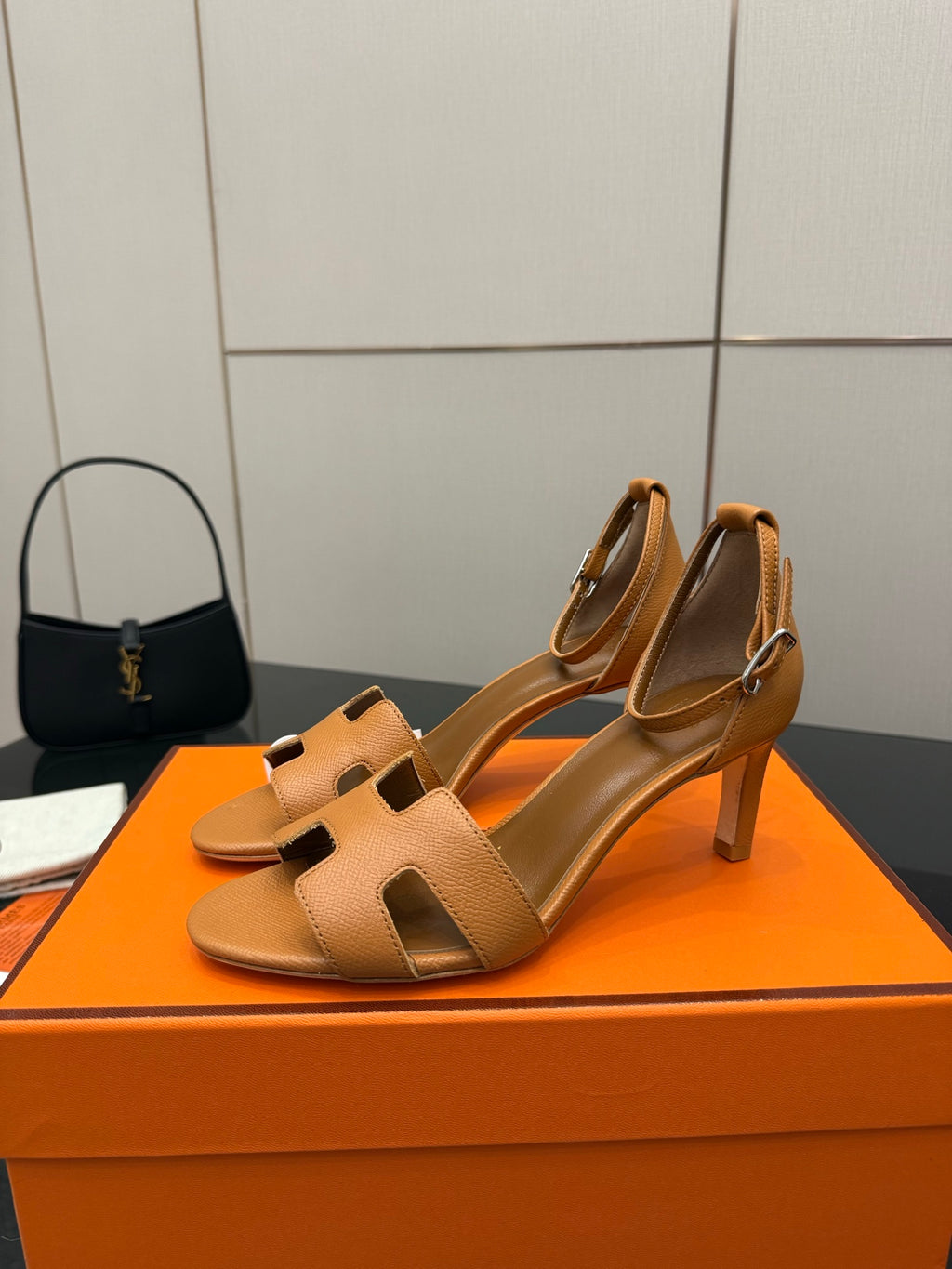 Tan leather heeled sandal with cutout strap and square toe opening, side view