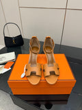 Tan leather heeled sandal with cutout straps and buckle detail, front view