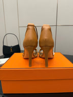 Hermes ladies tan heeled sandals, heel view showing back straps and stiletto