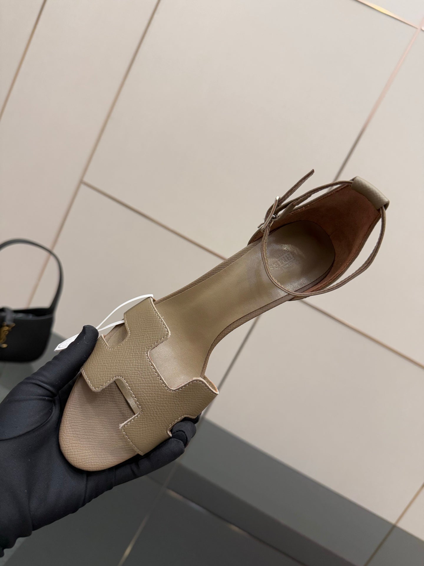 Light gray heeled sandal with open toe and ankle strap, shown from the side.