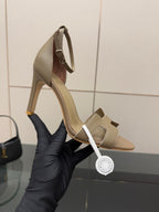 Ladies heeled sandals in light gray, close-up of straps and curved heel