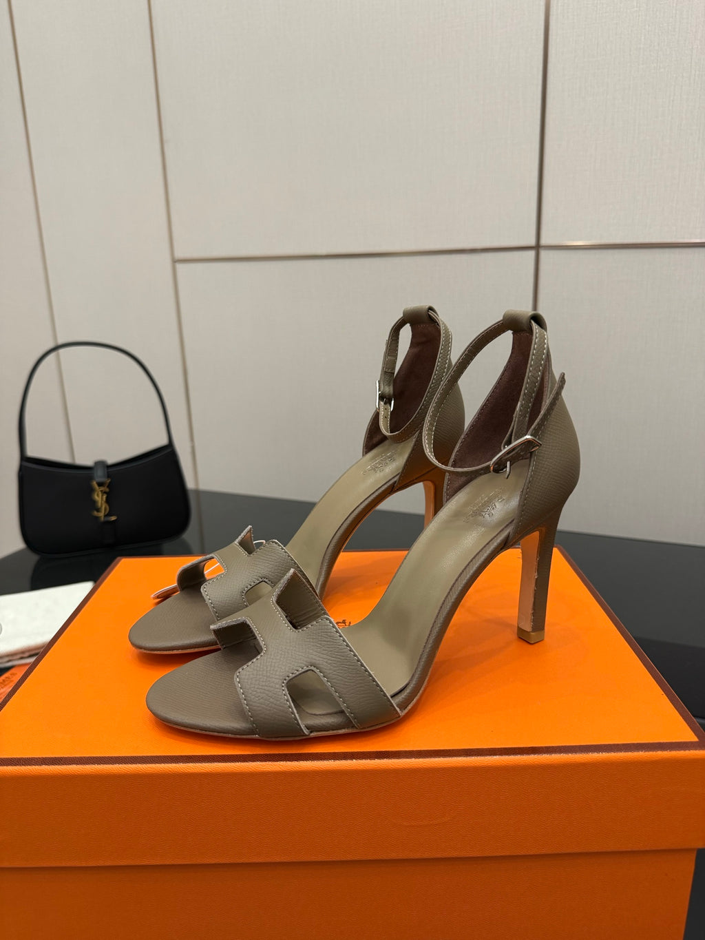 Ladies heeled sandals in light gray with open toe and ankle strap, angled view