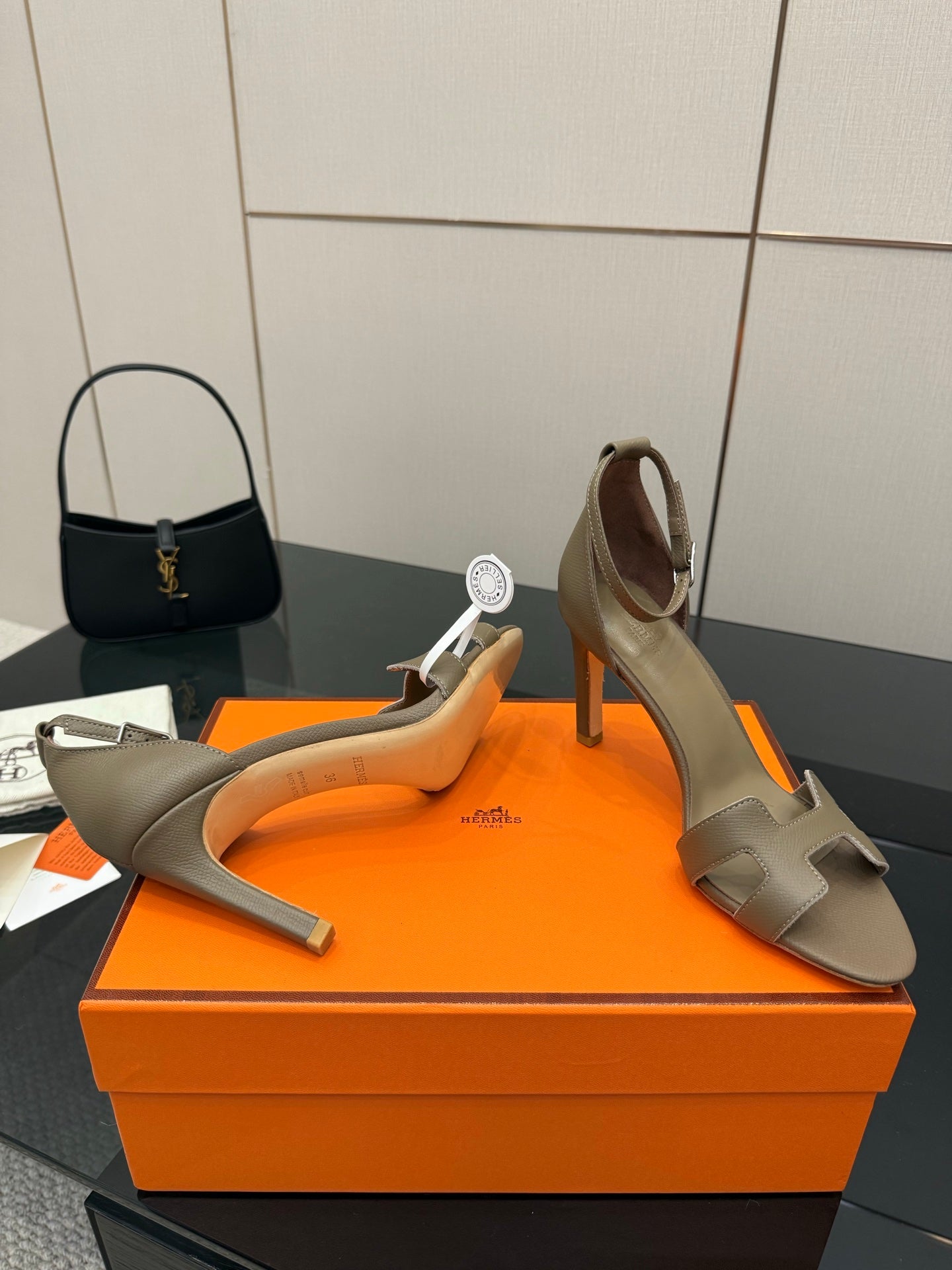 Ladies heeled sandals in light gray, front view showing cutout straps and heel