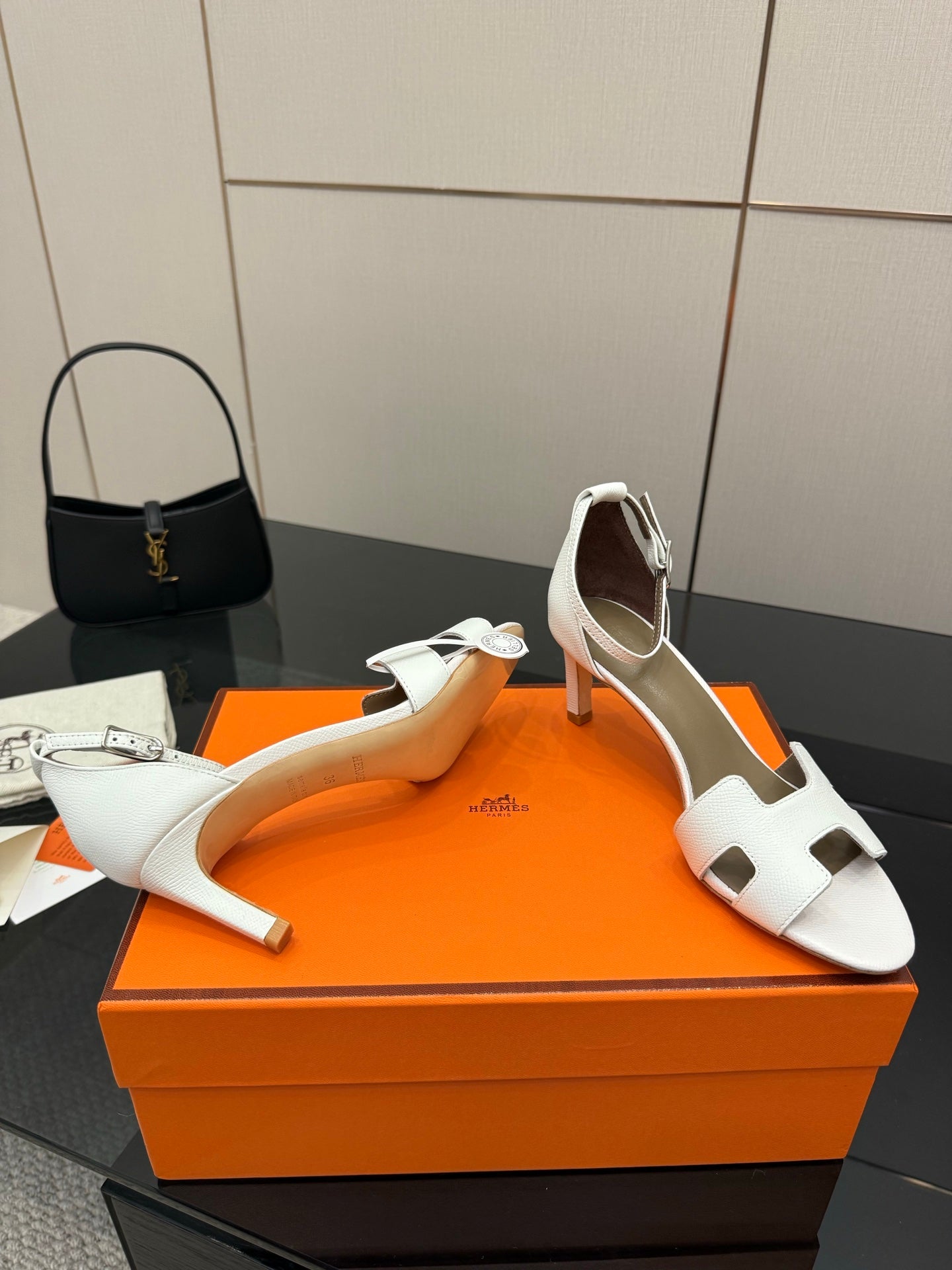 White strappy heeled sandals with open toe and ankle sling strap