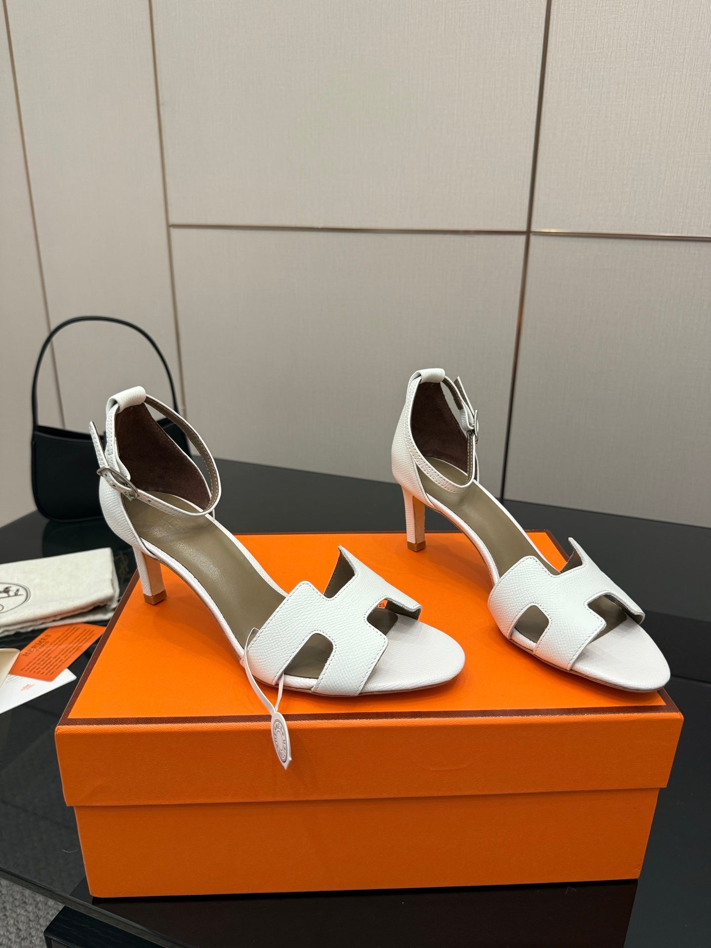 White heeled sandals with ankle strap and open toe, side view