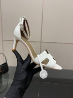 White strappy heeled sandals with open toe and ankle sling strap, side view