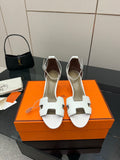White strappy heeled sandals with open toe and T-bar cutout design