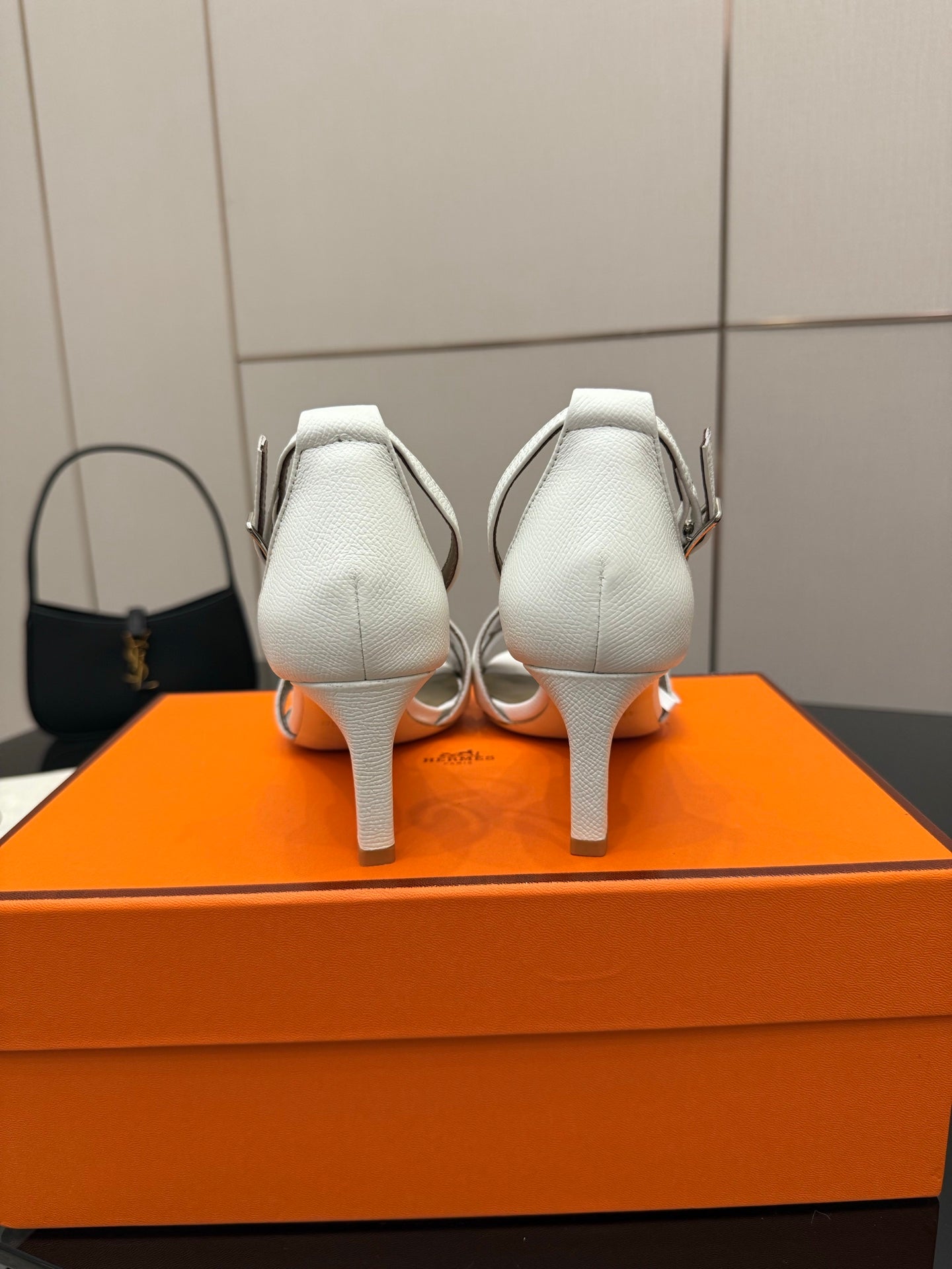 White heeled sandals, back view with adjustable ankle strap and slim heel