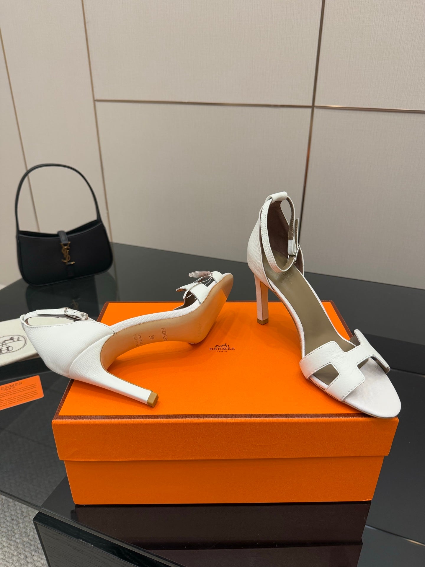 White heeled sandals with cutout strap and open toe on block heel