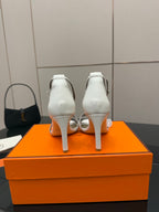 White heeled sandals, back view with ankle strap and slim block heel