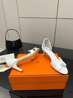 White leather sandals with block heel, angled view
