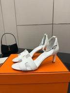 White leather slingback sandals with ankle strap, front angle