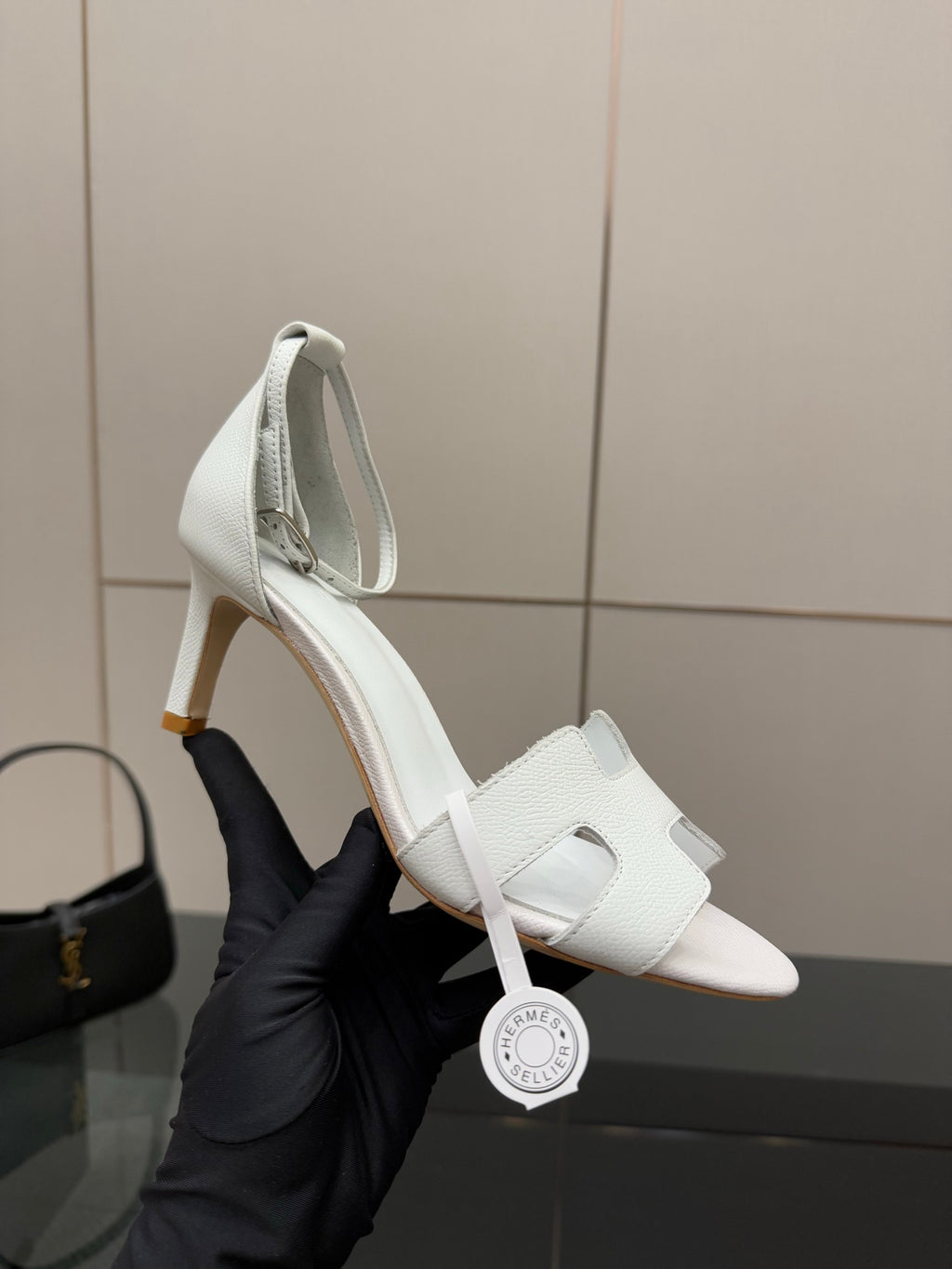 White leather slingback sandals, close side view on a heel