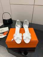White leather sandals with ankle strap and block heel, front view