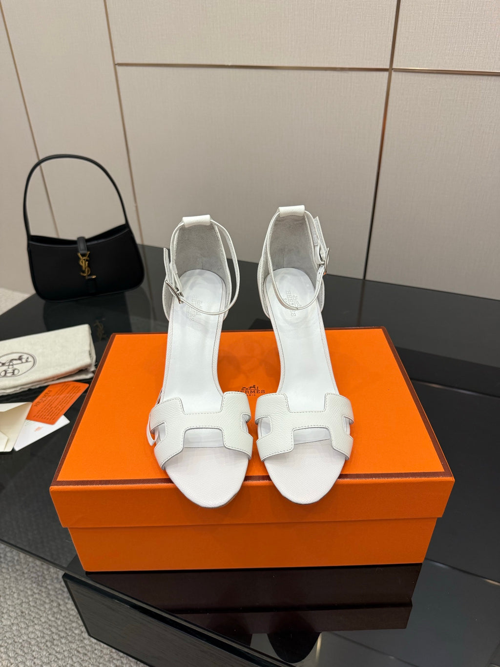 White heeled sandals with ankle strap, open toe, and double-buckle detail