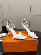 White heeled sandal with square toe, ankle strap, and block heel