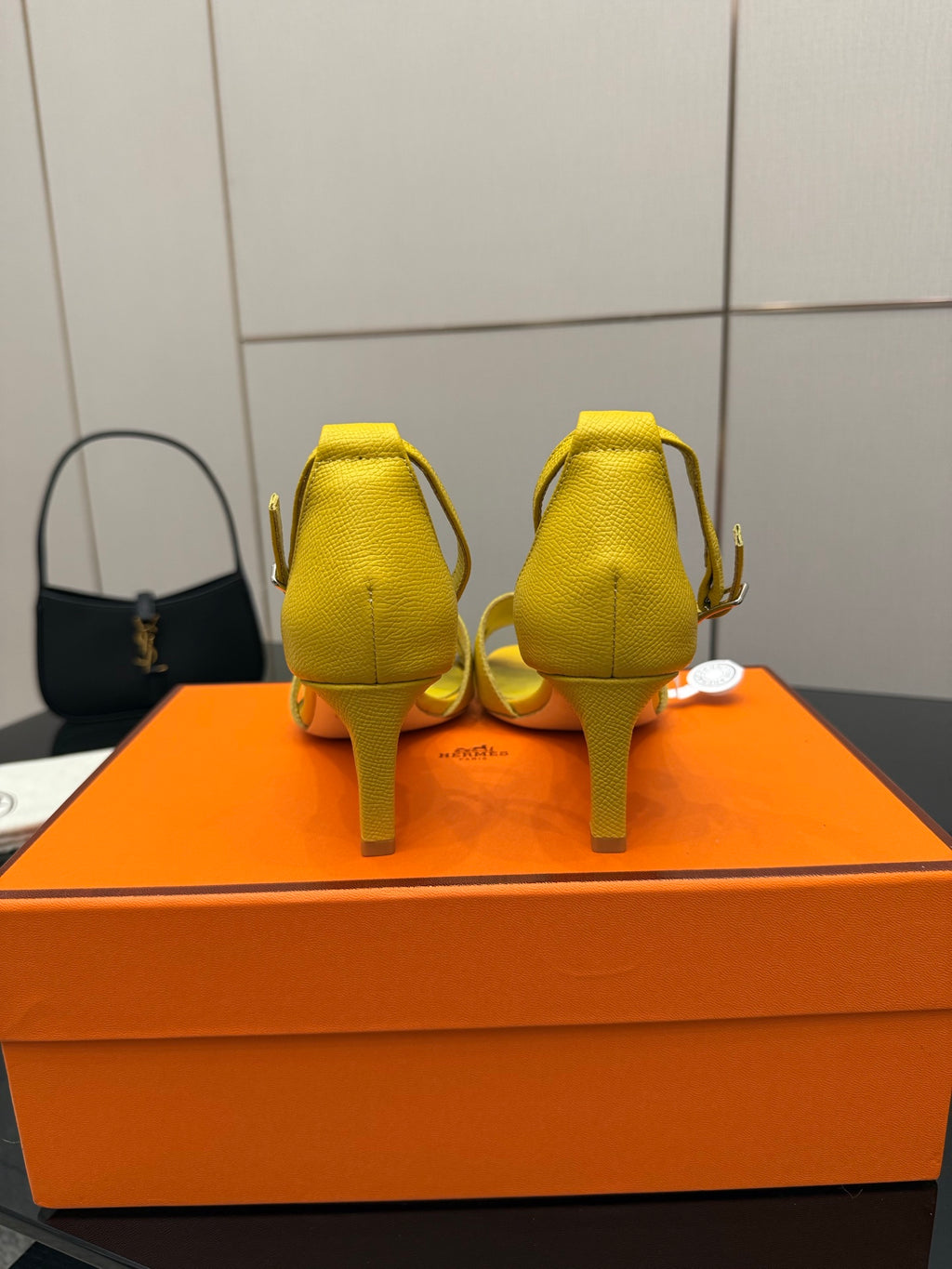 Yellow heeled sandals back view with slingback strap and slim heel