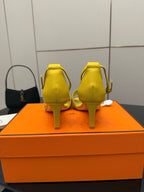 Yellow heeled sandals back view with slingback strap and slim heel