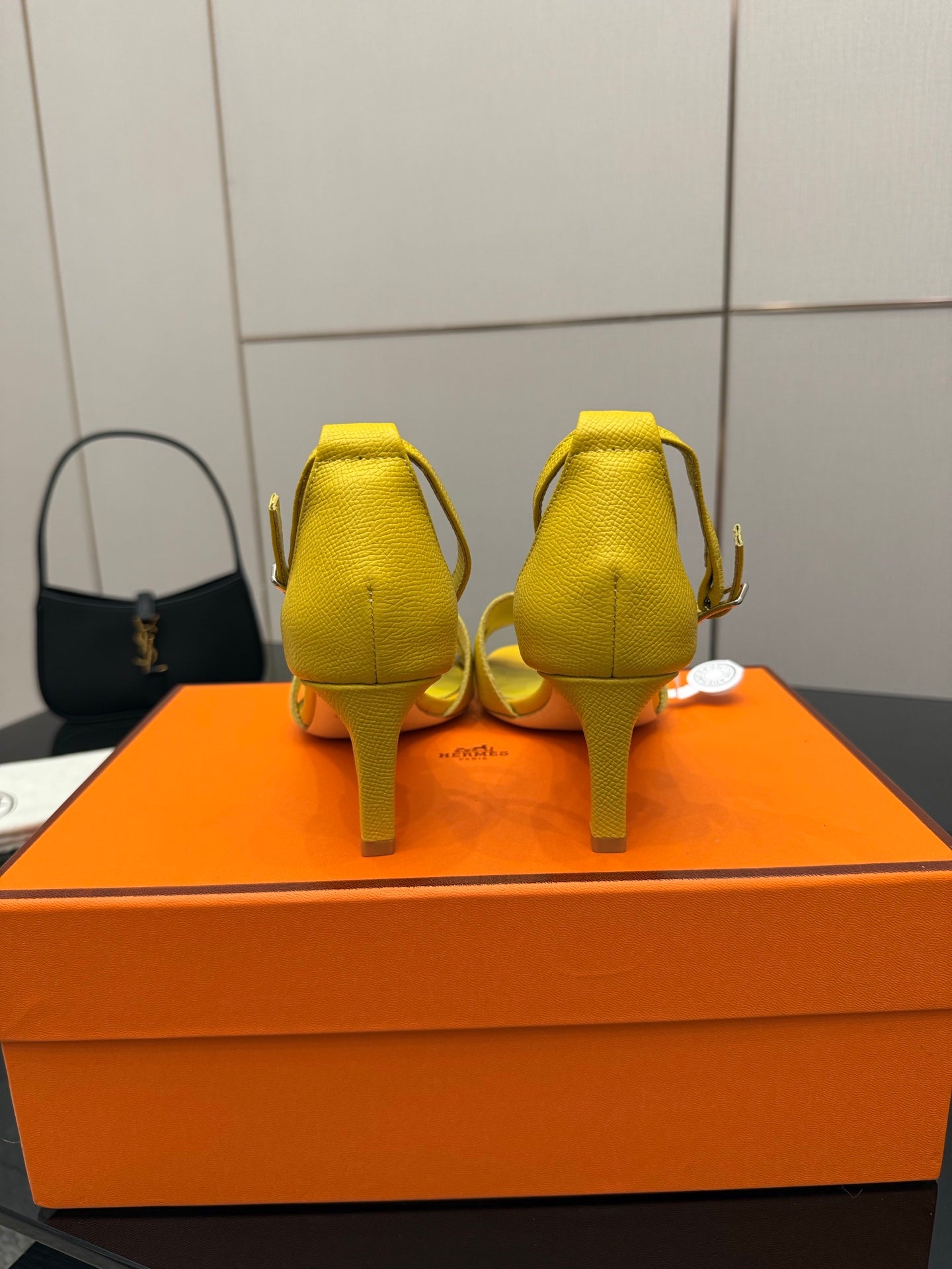 Yellow heeled sandals back view with slingback strap and slim heel