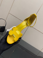 Yellow heeled sandal with textured strap and adjustable ankle strap