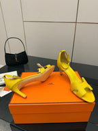Yellow heeled sandals with cross strap design and open toe