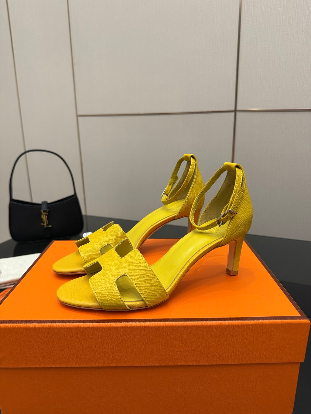 Yellow open-toe heeled sandals with wide straps and ankle buckle