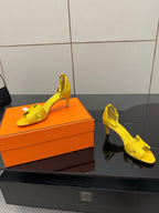 Yellow slingback heeled sandals with open toe and ankle strap detail