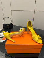 Hermes yellow heeled sandal pair, one shoe on side with open toe