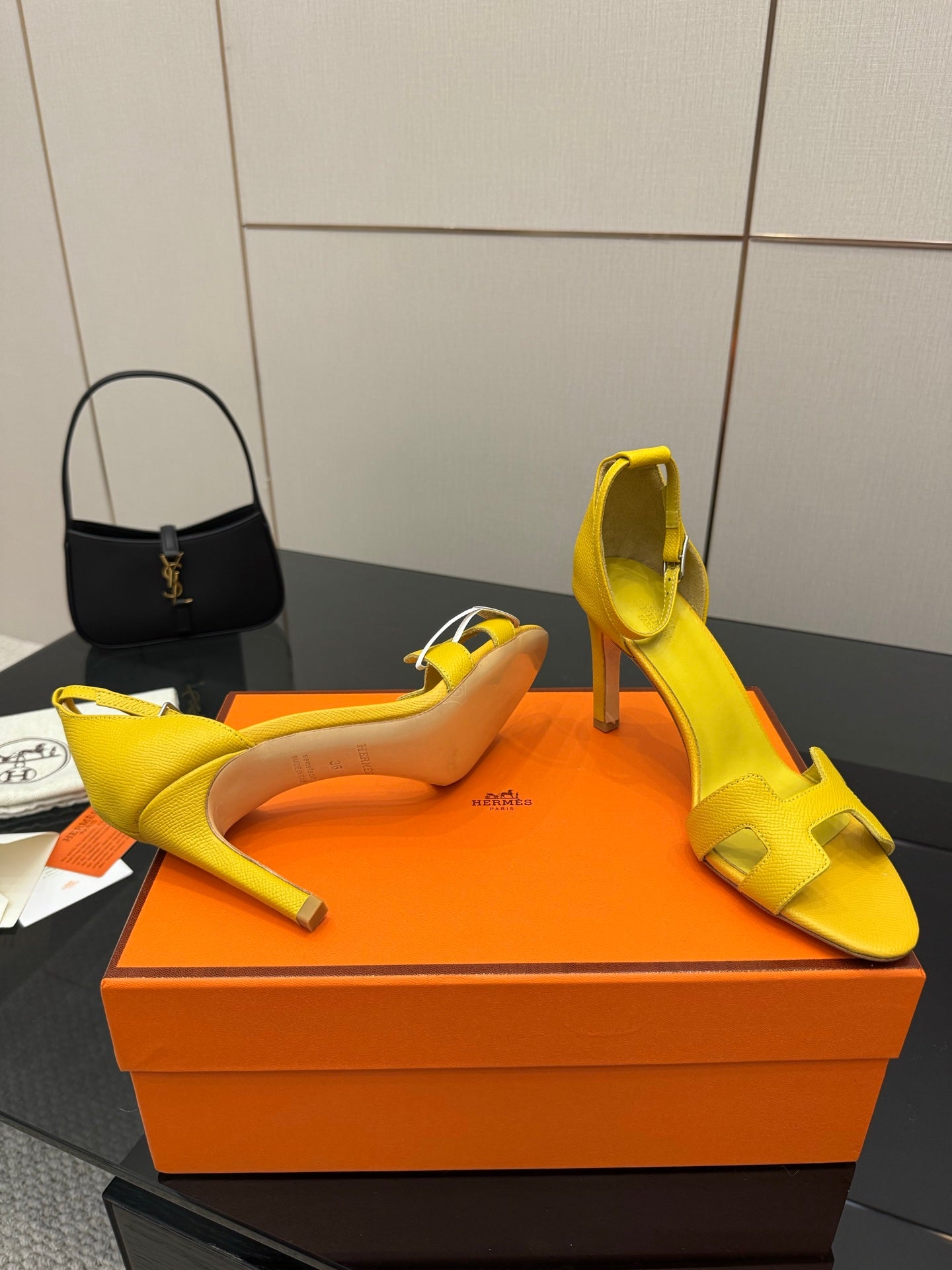 Hermes yellow heeled sandal pair, one shoe on side with open toe
