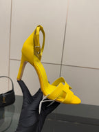 Hermes yellow heeled sandal on foot, close-up of ankle strap and heel