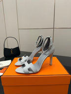 Ladies' light-gray heeled sandals with open toe and sculpted ankle strap
