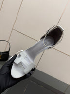 Ladies' light-gray heeled sandal close-up with open toe and ankle strap