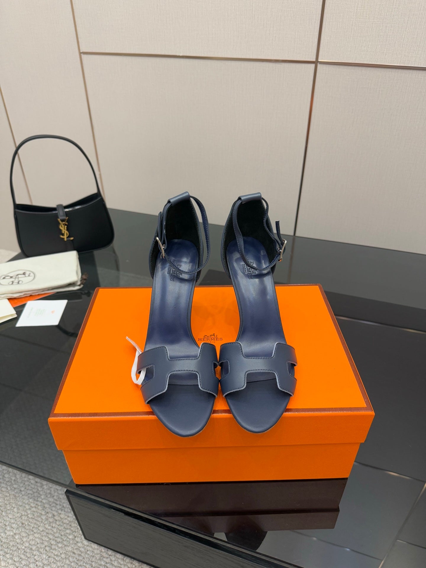 Hermes blue leather heeled sandals with ankle strap, buckle, and open toe cutouts