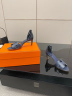 Pair of ladies blue heeled sandals with ankle strap and open toe